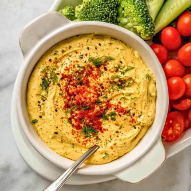 Creamy Deviled Egg Dip served in a bowl with crackers and vegetables