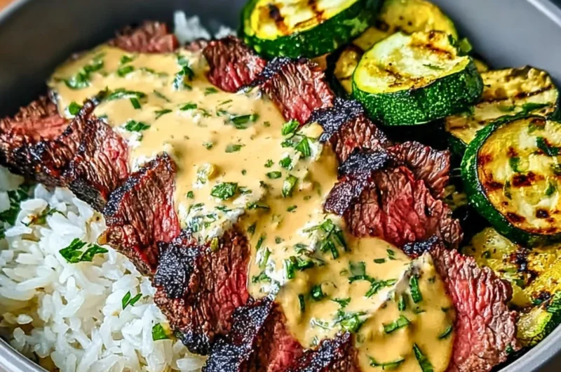 Grilled steak bowl with sauce and sliced grilled zucchini served in a bowl