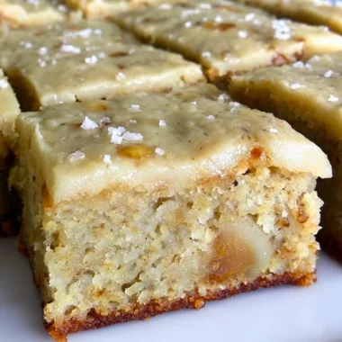 Irresistible banana bread brownies with brown butter frosting on a plate