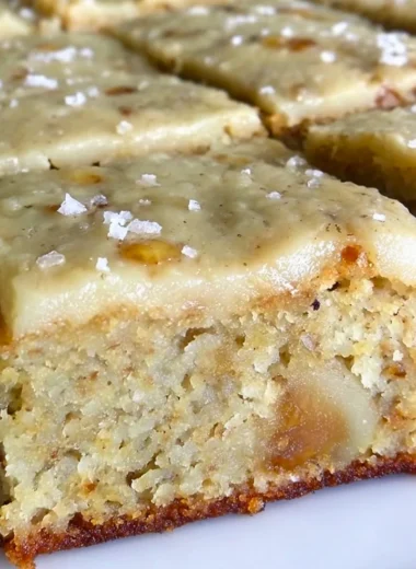 Irresistible banana bread brownies with brown butter frosting on a plate