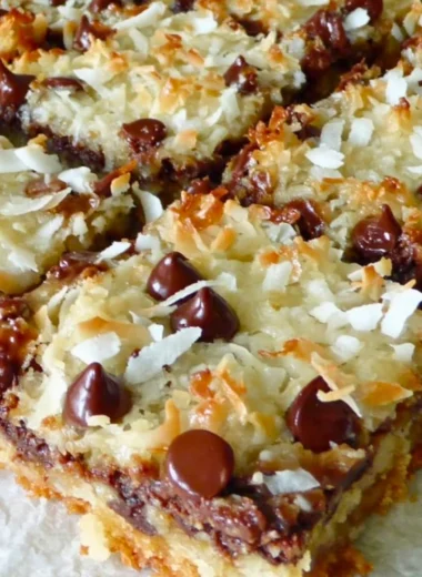 Decadent Magic Cookie Bars with layers of chocolate, coconut, and nuts