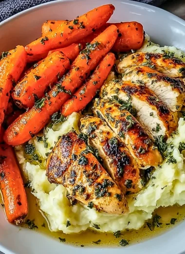 Garlic Herb Chicken with mashed potatoes and glazed carrots on a plate