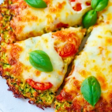 Zucchini pizza crust topped with fresh ingredients and cheese