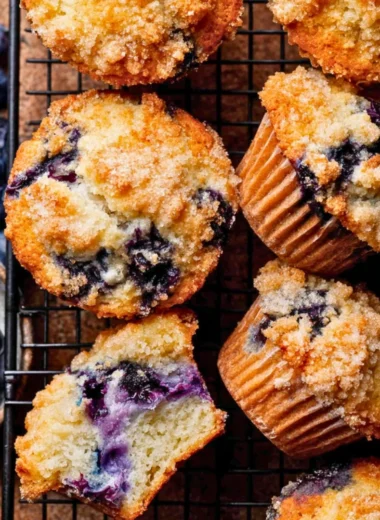Bakery style blueberry muffins fresh out of the oven, golden brown and fluffy