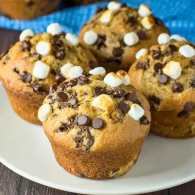 Deliciously baked Banana S'mores Muffins with chocolate and marshmallow topping