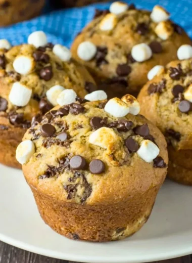 Deliciously baked Banana S'mores Muffins with chocolate and marshmallow topping