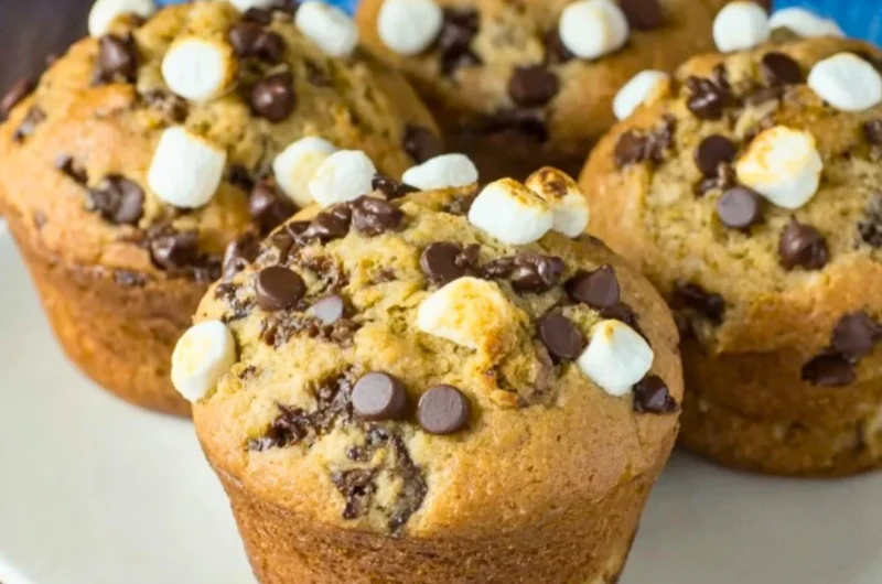 Deliciously baked Banana S'mores Muffins with chocolate and marshmallow topping