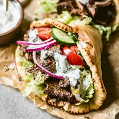Delicious homemade Beef Gyros served with fresh toppings.