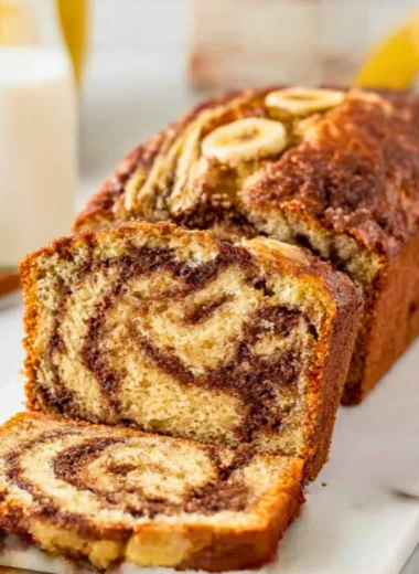 Freshly baked Cinnamon Swirl Banana Bread with a swirl of cinnamon on top.