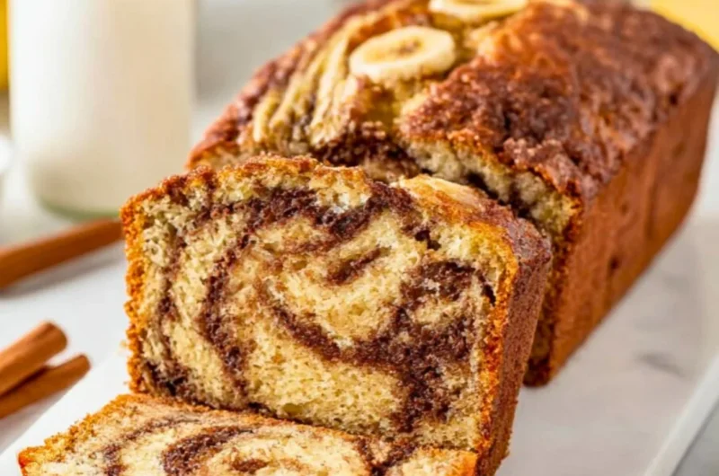 Freshly baked Cinnamon Swirl Banana Bread with a swirl of cinnamon on top.