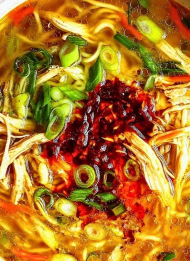 Bowl of Classic Ginger Garlic Chicken Noodle Soup with fresh herbs and chicken