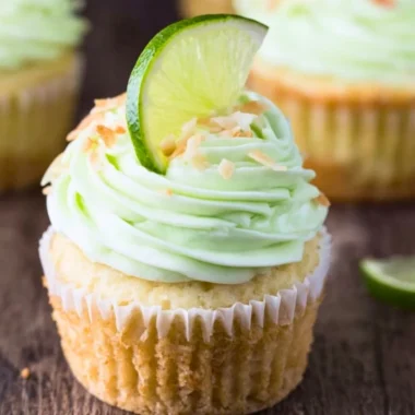 Coconut cupcakes with lime buttercream frosting on a decorative plate