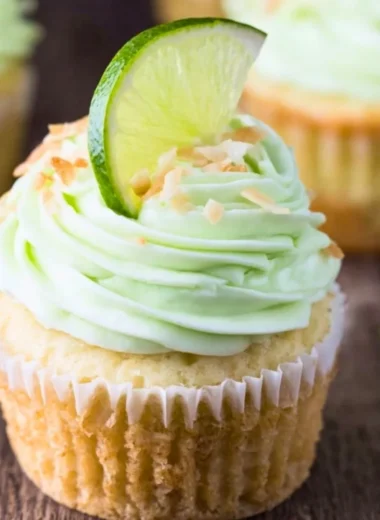Coconut cupcakes with lime buttercream frosting on a decorative plate