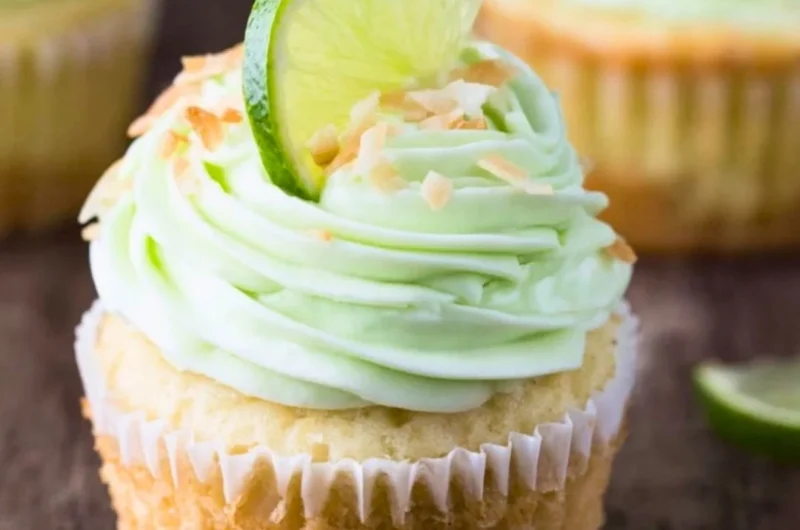 Coconut cupcakes with lime buttercream frosting on a decorative plate