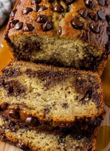 Loaf of easy chocolate chip banana bread with chocolate chips and bananas
