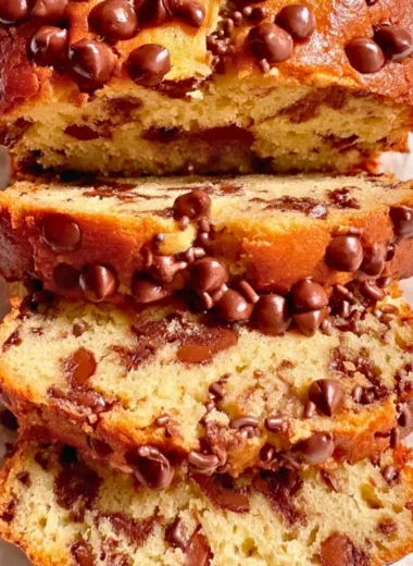 Delicious Greek Yogurt Cake topped with fresh berries and whipped cream