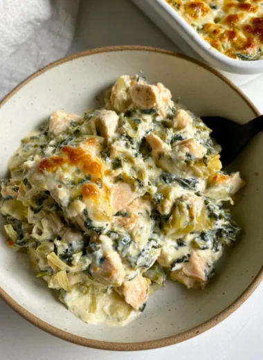 High-protein spinach artichoke chicken casserole in a baking dish