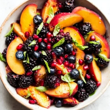 Delicious honey lime basil peach fruit salad with vibrant ingredients