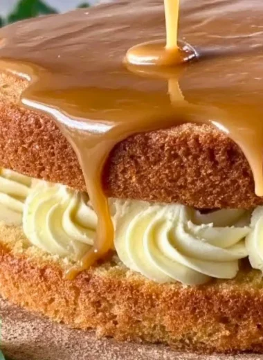 Delicious slice of Irish Whiskey Cake topped with creamy frosting and whiskey drizzle