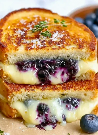 Juicy blueberry grilled cheese sandwich with melting cheese and fresh blueberries