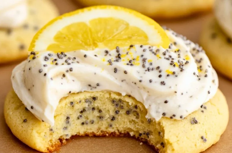 Lemon poppy seed cookies decorated with cheesecake frosting on a plate.