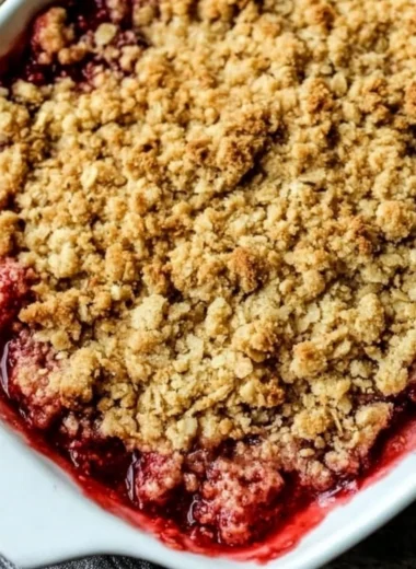 Delicious old-fashioned strawberry rhubarb crisp dessert with a golden topping