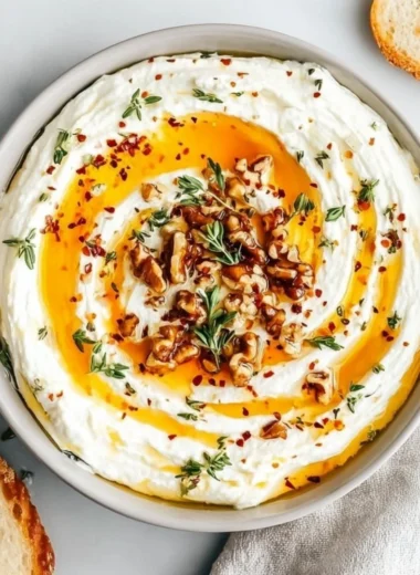 Creamy ricotta dip drizzled with hot honey served in a bowl