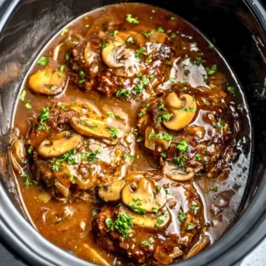 Delicious slow cooker Salisbury steak served with creamy mashed potatoes.