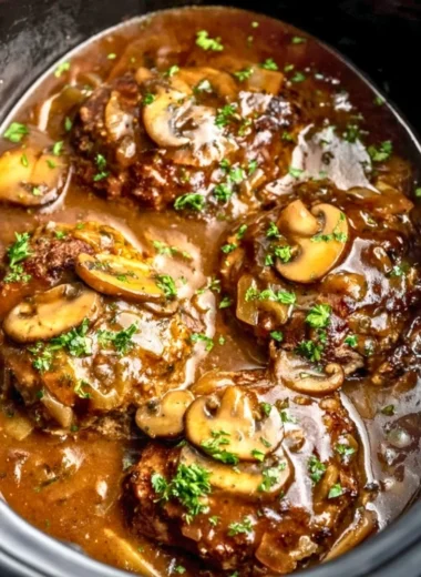 Delicious slow cooker Salisbury steak served with creamy mashed potatoes.