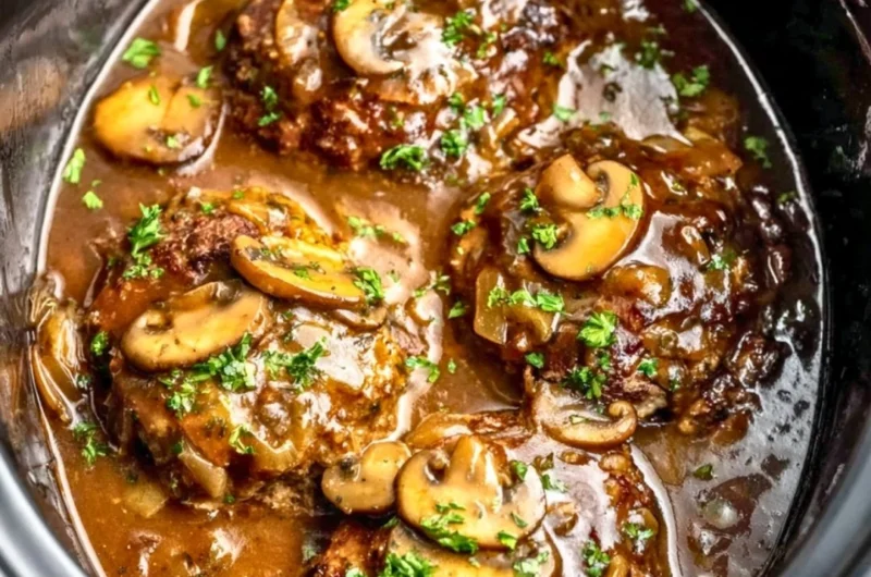 Delicious slow cooker Salisbury steak served with creamy mashed potatoes.