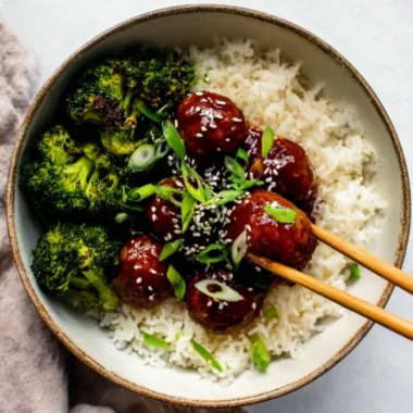 Delicious Sticky Mongolian Beef Meatballs served in a bowl with garnishes