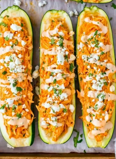 Buffalo Chicken Stuffed Zucchini Boats garnished and ready to serve
