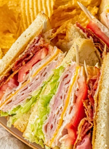 Delicious club sandwich with layers of turkey, bacon, lettuce, and tomato.