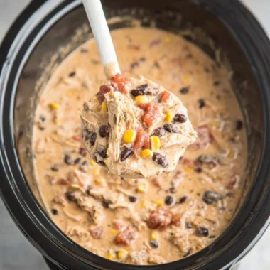 Bowl of creamy Crockpot White Chicken Chili topped with cilantro and lime