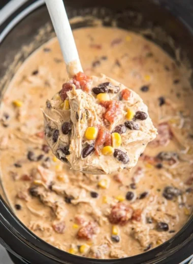 Bowl of creamy Crockpot White Chicken Chili topped with cilantro and lime