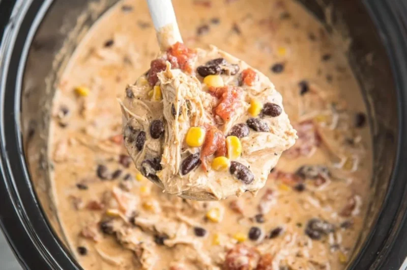 Bowl of creamy Crockpot White Chicken Chili topped with cilantro and lime