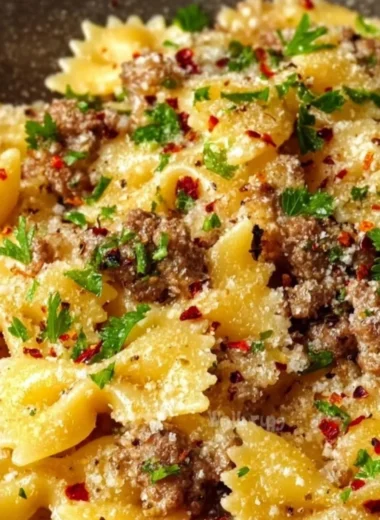 Delicious garlic butter bowtie pasta with ground beef served in a bowl.