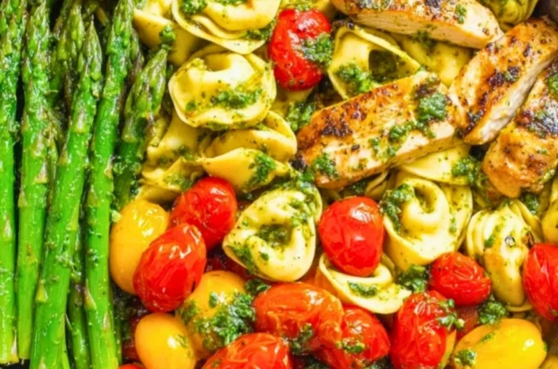 One-Pan Pesto Chicken with tortellini and mixed vegetables in a skillet