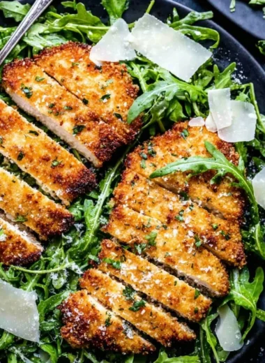 Crispy air-fryer chicken breast on a plate garnished with herbs