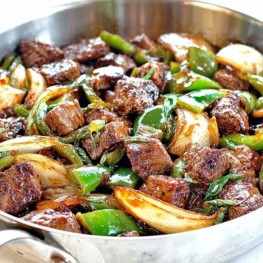Delicious teriyaki steak bites with green pepper and onion served on a plate