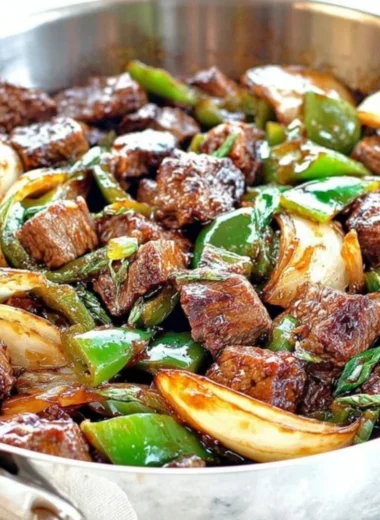 Delicious teriyaki steak bites with green pepper and onion served on a plate