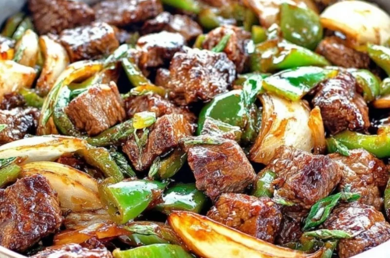 Delicious teriyaki steak bites with green pepper and onion served on a plate