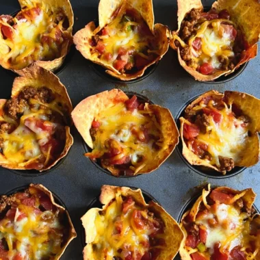 Cozy taco muffins topped with cheese and herbs, perfect for a savory snack