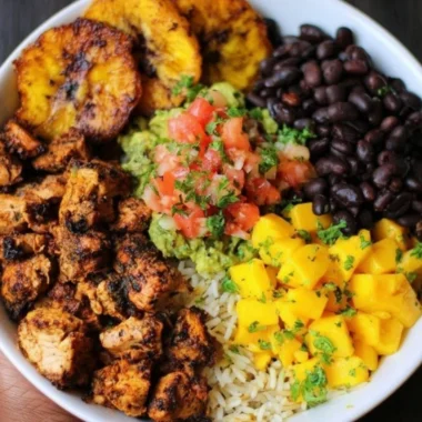Cuban Chicken served with Black Bean Rice in a colorful bowl.
