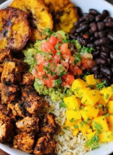 Cuban Chicken served with Black Bean Rice in a colorful bowl.