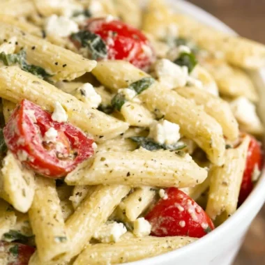 Colorful Greek Pasta Salad with vegetables and feta cheese in a bowl