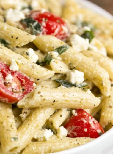 Colorful Greek Pasta Salad with vegetables and feta cheese in a bowl