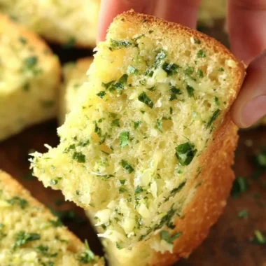 Freshly baked homemade garlic bread with herbs and melted butter