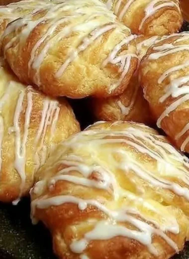 Freshly baked Individual Cream Cheese Danish pastry with creamy filling.