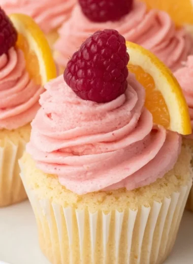 Lemon cupcakes with raspberry buttercream frosting on a decorative plate
